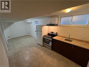 Kitchener apartment for rent - A kitchen with a refrigerator, oven, and sink.