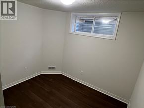 Kitchener apartment for rent - A room with a window and wooden flooring.