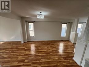 Kitchener apartment for rent - A room with wooden flooring and a chandelier hanging from the ceiling.