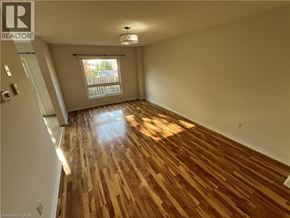 Kitchener apartment for rent - A room with wooden flooring and a window.