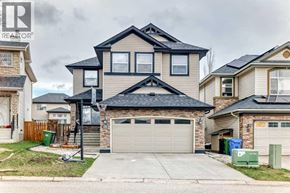 Calgary apartment for rent - A house with a garage and a basketball hoop in front.