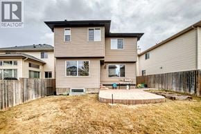 Calgary apartment for rent - A house with a brown fence and a small patio.