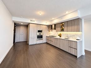 Surrey apartment for rent - A modern kitchen with wooden floors and cabinets.