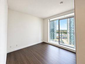 Surrey apartment for rent - Empty room with a view of the cityscape outside.