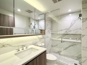 Surrey apartment for rent - A modern bathroom with marble tiles and a walk-in shower.