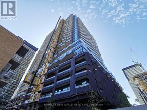 Toronto (Mount Pleasant West) condo for rent - A tall building under construction with a crane visible in the background.