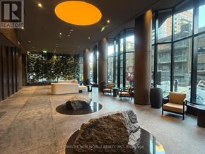 Toronto (Mount Pleasant West) condo for rent - A large, modern lobby with a stone floor and a large window.