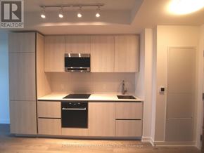 Toronto (Mount Pleasant West) condo for rent - A modern kitchen with wooden cabinets and stainless steel appliances.