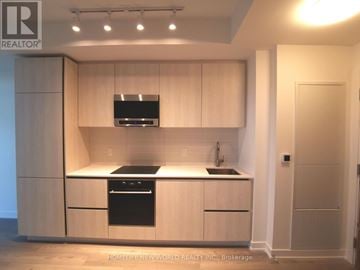 Toronto (Mount Pleasant West) condo for rent - A modern kitchen with wooden cabinets and stainless steel appliances.