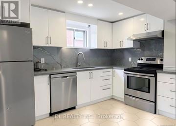 Toronto (Pleasant View) apartment for rent - A modern kitchen with stainless steel appliances and white cabinets.