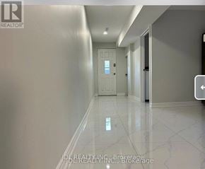 Toronto (Pleasant View) apartment for rent - A long hallway with a white door at the end.