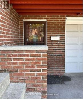 Toronto (Pleasant View) apartment for rent - A red brick house with a white door and a window.