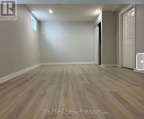 Toronto (Pleasant View) apartment for rent - A room with wooden flooring and a white door.