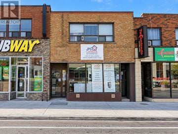 Toronto (Keelesdale-Eglinton West) townhouse for rent - A brick building with a Subway and JP's Pizza storefronts.