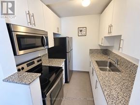 Toronto (Keelesdale-Eglinton West) townhouse for rent - A kitchen with granite countertops and stainless steel appliances.