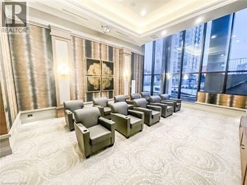 Mississauga condo for rent - A living room with grey couches and a large window.