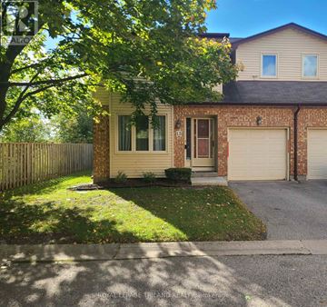London South (South X) townhouse for rent - A house with a garage and a tree in front.