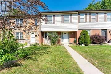 Mississauga (Meadowvale) townhouse for rent - A building with a lawn in front of it.