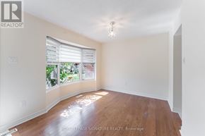 Mississauga (Meadowvale) townhouse for rent - A room with wooden floors and a window with blinds.
