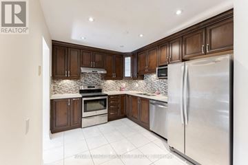 Mississauga (Meadowvale) townhouse for rent - A kitchen with brown cabinets and a stainless steel refrigerator.
