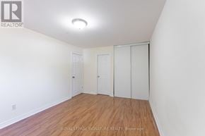 Mississauga (Meadowvale) townhouse for rent - A white room with wood floors and a ceiling light.