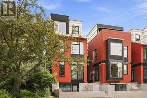 Ottawa apartment for rent - A modern red brick building with black windows and a tree in front.