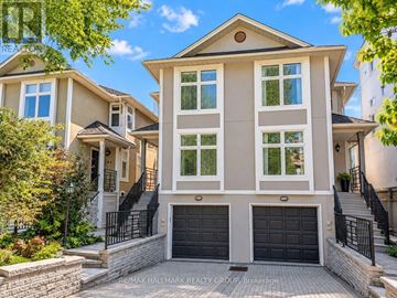Ottawa apartment for rent - A large, two-story house with a garage is surrounded by a well-maintained lawn and a stone wall.