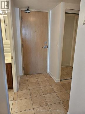 Toronto (Willowdale West) condo for rent - A wooden door is in a room with tiled flooring.