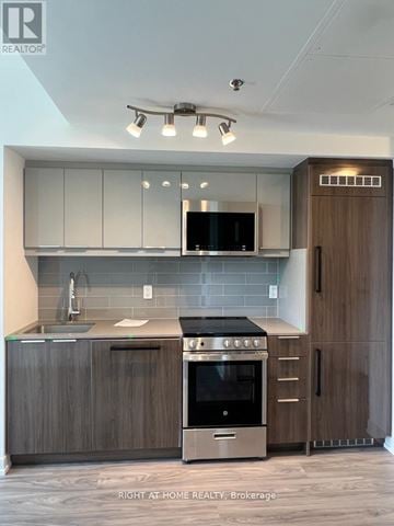 Toronto (Birchcliffe-Cliffside) condo for rent - A modern kitchen with a stainless steel oven and microwave.