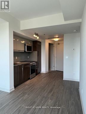 Toronto (Birchcliffe-Cliffside) condo for rent - A kitchen with wood floors and white walls.