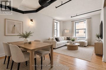 London East (East K) multi-family for rent - A well-lit, modern living room with a dining table and chairs.