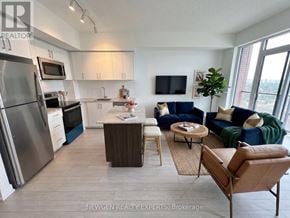 Toronto (Humber Heights) condo for rent - A modern kitchen with a refrigerator, microwave, and oven.