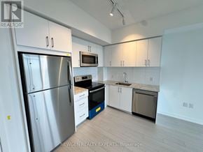 Toronto (Humber Heights) condo for rent - A kitchen with a refrigerator, microwave, oven, and sink.