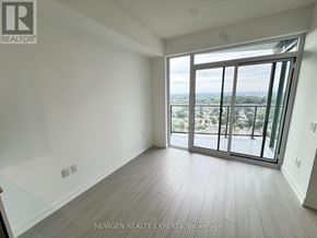 Toronto (Humber Heights) condo for rent - A room with a view of the city through large windows.