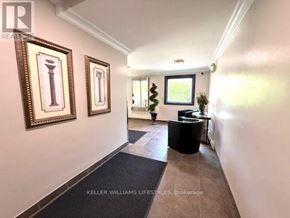 London East (East F) condo for rent - A hallway with a black trash can and two framed pictures on the wall.