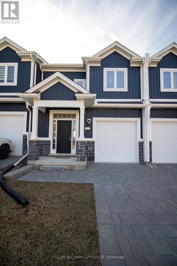 London North (North I) townhouse for rent - A modern house with a dark blue exterior and white trim.