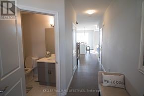 London North (North I) townhouse for rent - A hallway with a white pillow that says "welcome" on it.