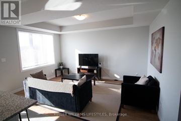London North (North I) townhouse for rent - A living room with a black couch and a television.