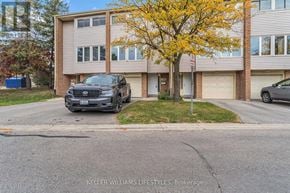 London South (South Y) townhouse for rent - A black SUV is parked in front of a two-story apartment building.
