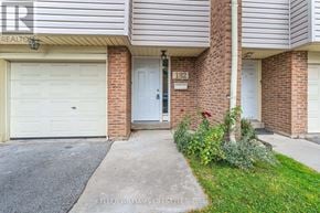London South (South Y) townhouse for rent - A house with a white garage door and a brick wall.