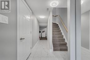 London South (South Y) townhouse for rent - A hallway with a staircase and a door.