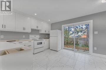 London South (South Y) townhouse for rent - A kitchen with white cabinets and appliances is on the market.