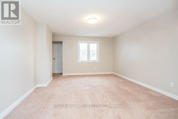 London North (North F) townhouse for rent - A spacious room with a carpeted floor and a window.