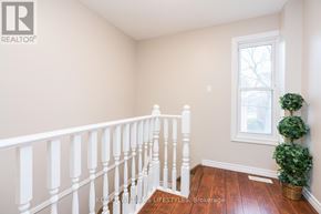 London North (North F) townhouse for rent - A room with a white railing and a window.