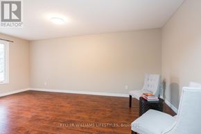 London North (North F) townhouse for rent - A room with a wooden floor and a white chair.