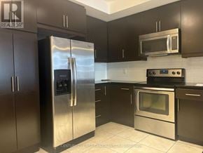 London East (East K) condo for rent - A kitchen with a stainless steel refrigerator and oven.