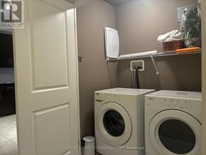 London East (East K) condo for rent - A brokerage sign is on the wall above a washer and dryer.