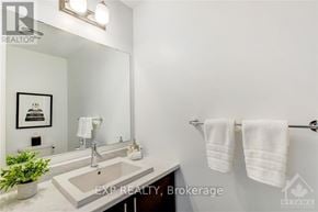 Ottawa townhouse for rent - A bathroom with a sink, mirror, and towel rack.