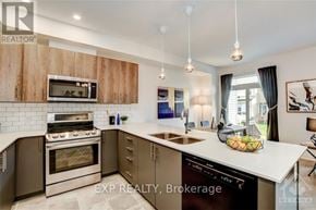 Ottawa townhouse for rent - A kitchen with wooden cabinets and a white countertop.