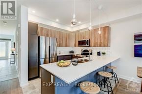 Ottawa townhouse for rent - A modern kitchen with wooden cabinets and a large island.